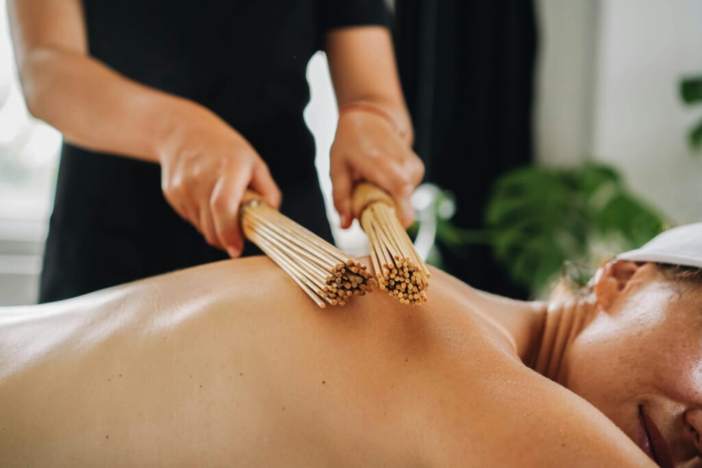 A soothing bamboo stick massage in a serene spa setting, promoting relaxation and wellness.